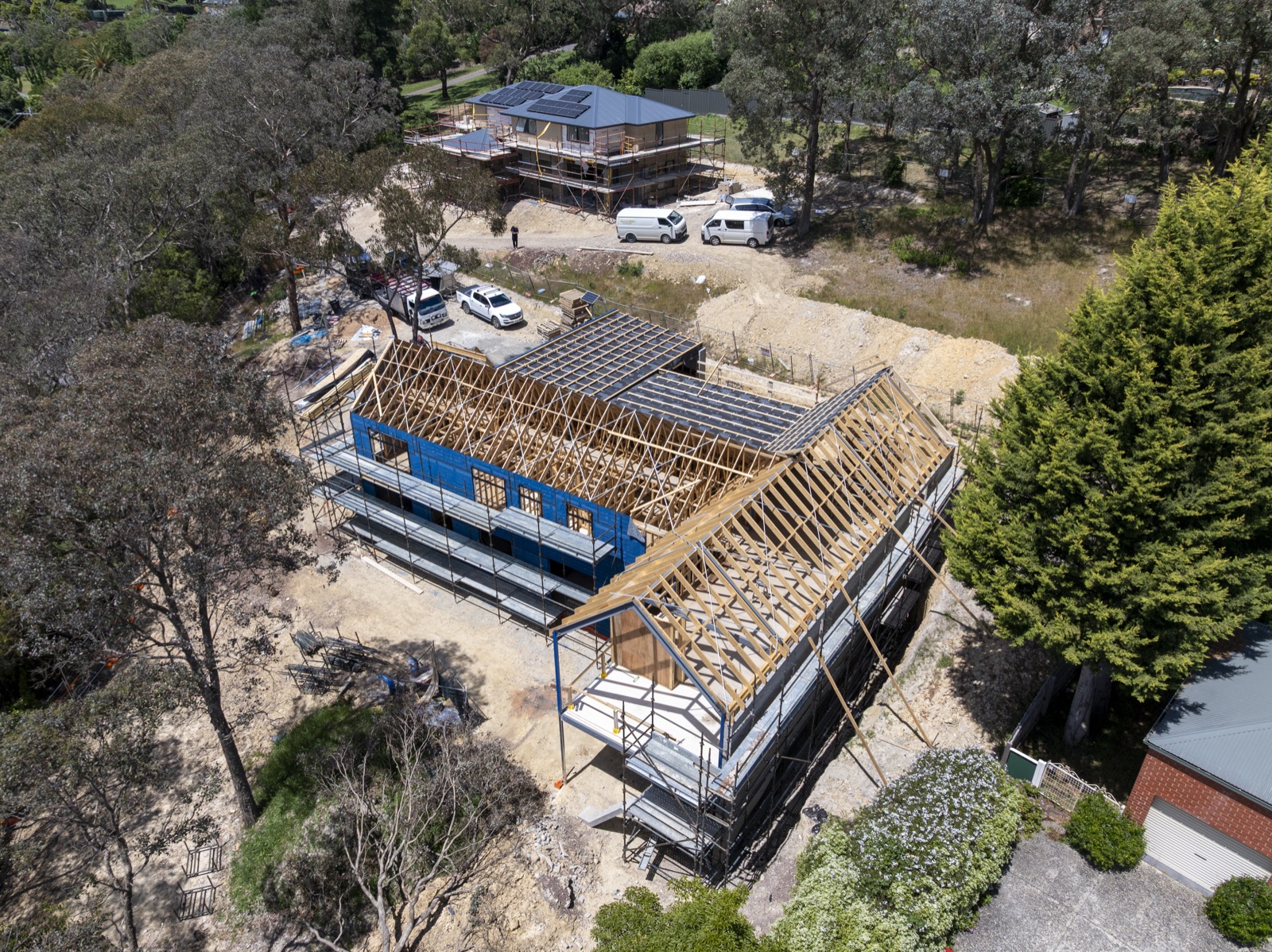 Aerial of a two storey home under frame with the roof trusses set