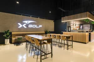 The illuminated XGOLF sign above the bar and high tables at reception