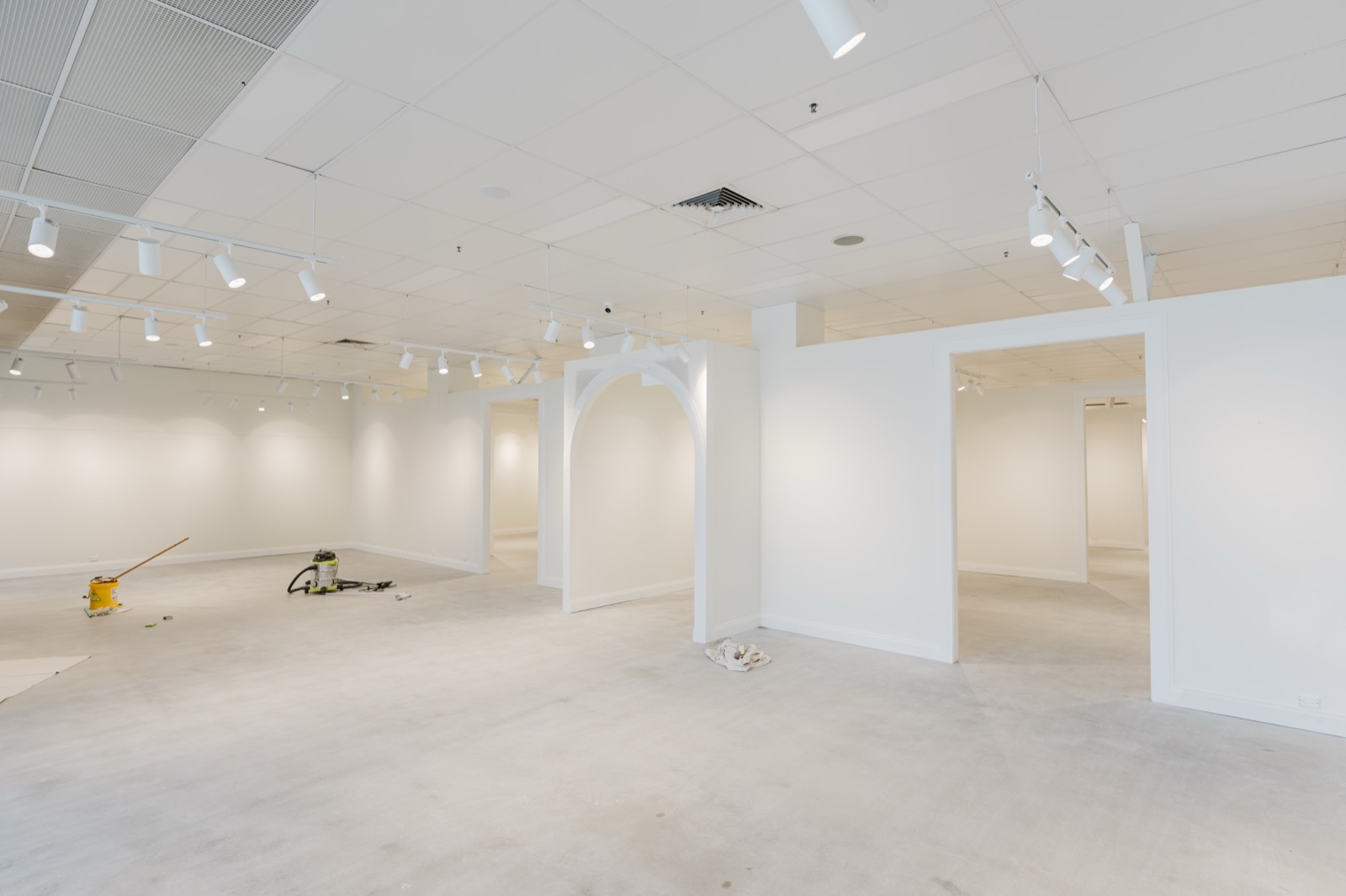 An empty retail tenancy stripped back to white before fitout