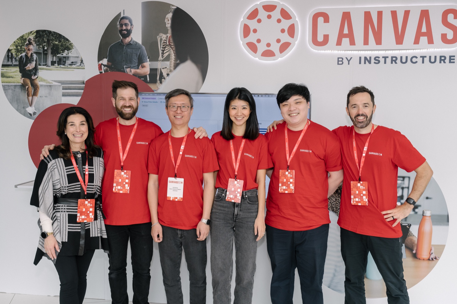 The conference crew lined up under the event sign