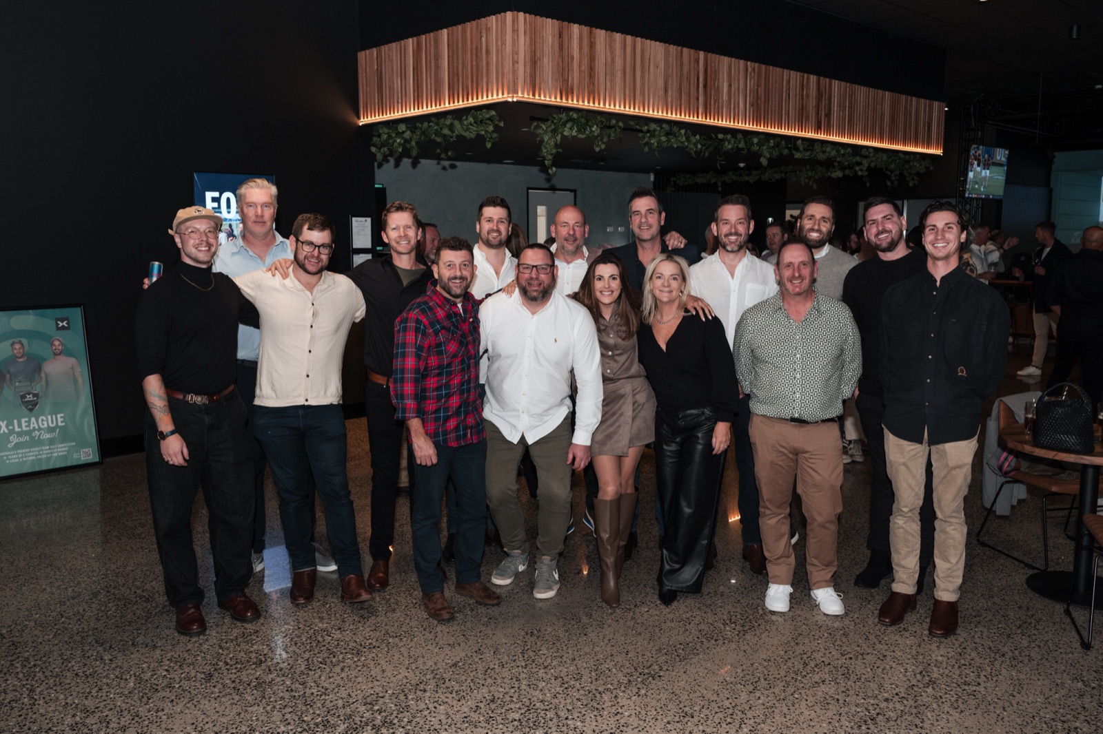 The full group photographed at an evening venue