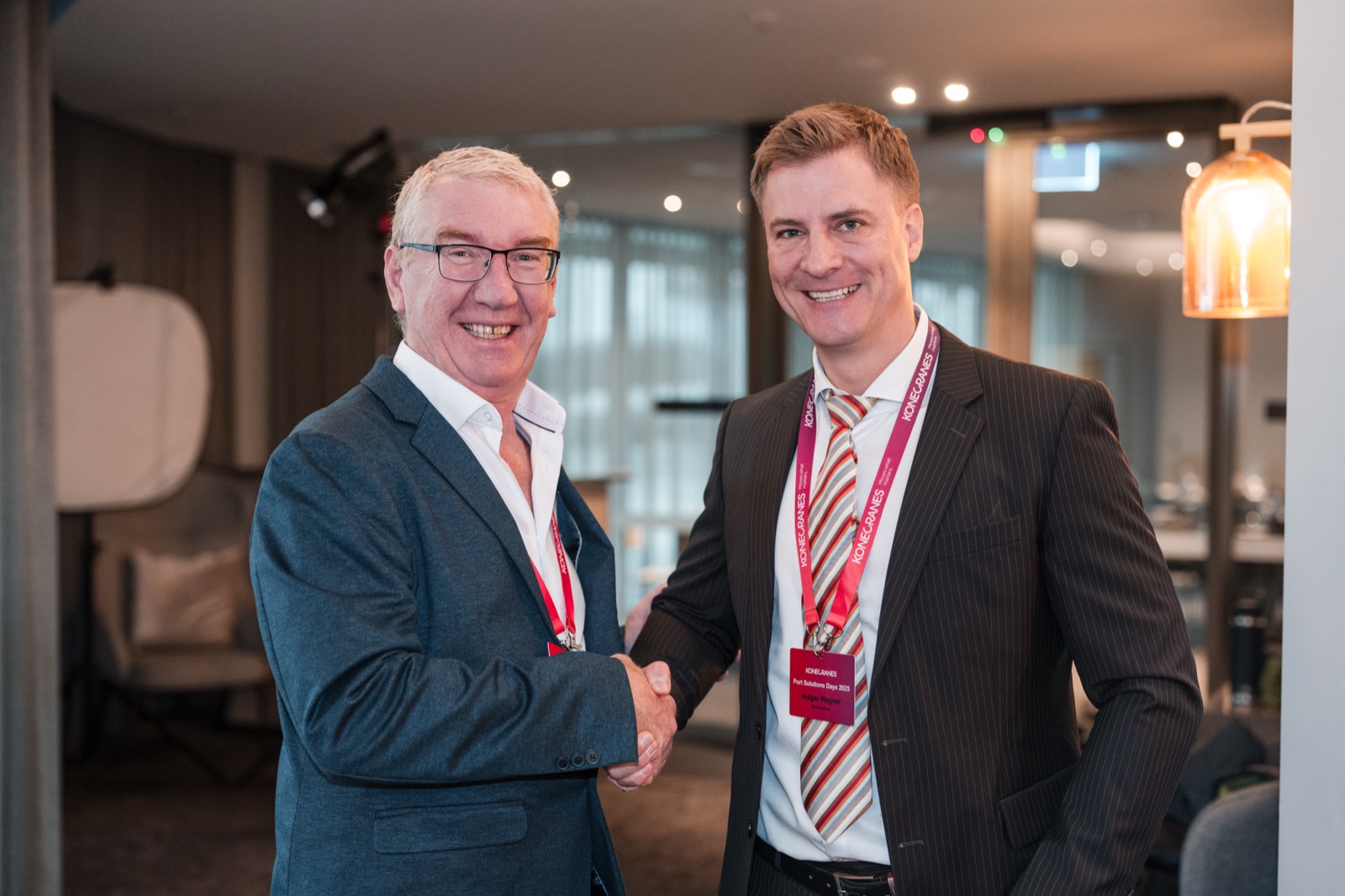 Two delegates shaking hands at an industry function