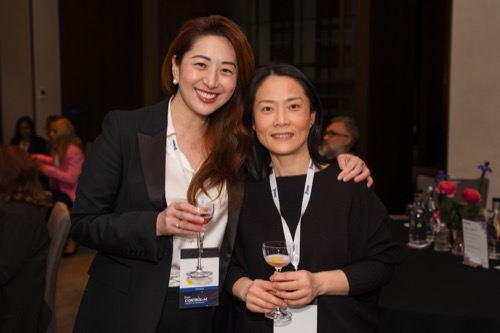 Conference guests networking with drinks and name badges at an evening function