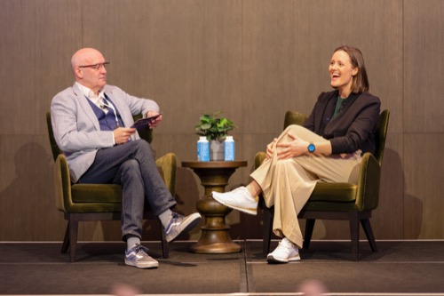 Fireside chat between two speakers on a Melbourne conference stage