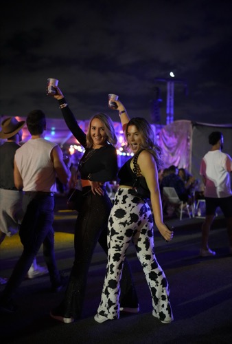 Guests dancing at an outdoor evening festival activation