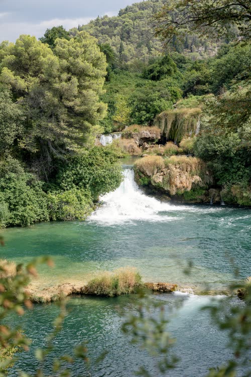 Cascades falling into a clear green pool at Krka National Park, Croatia