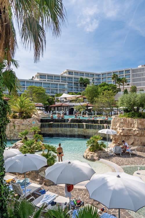 Sun umbrellas and a hotel pool above the Adriatic, Croatia