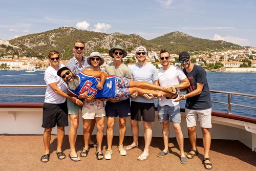 A group of friends posing together on the deck of a cruise boat, Croatia