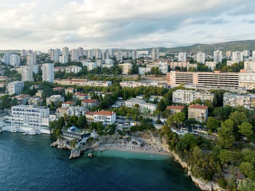 Aerial view of apartment blocks along the rocky waterfront at Rijeka, Croatia