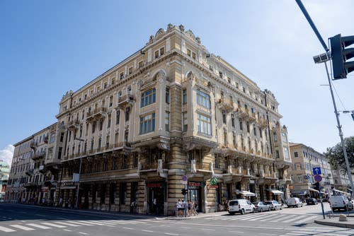 An ornate corner building on a city street in Rijeka, Croatia
