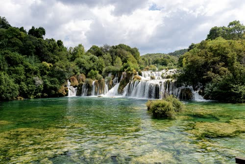 Waterfalls spilling into the green pool at Skradinski Buk, Krka, Croatia