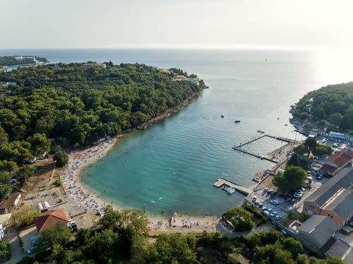 Aerial view of a beach, marina and wooded point on the Istrian coast, Croatia
