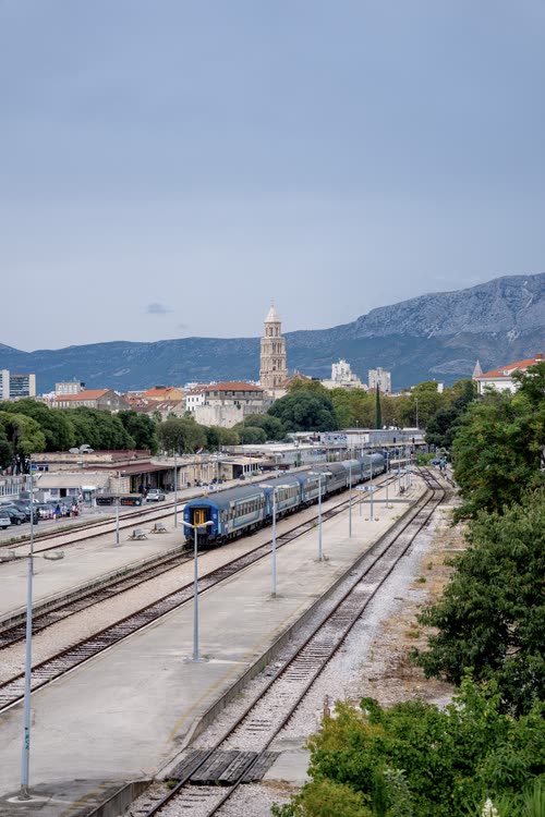 Trains in the station at Split with the cathedral tower and hills beyond, Croatia