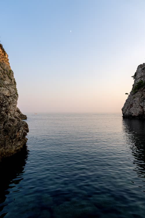 Calm sea between two limestone cliffs at first light, Croatia