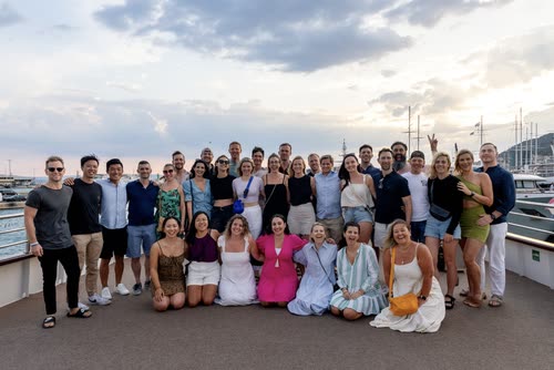 A large tour group posed on the quay at sunset, Croatia