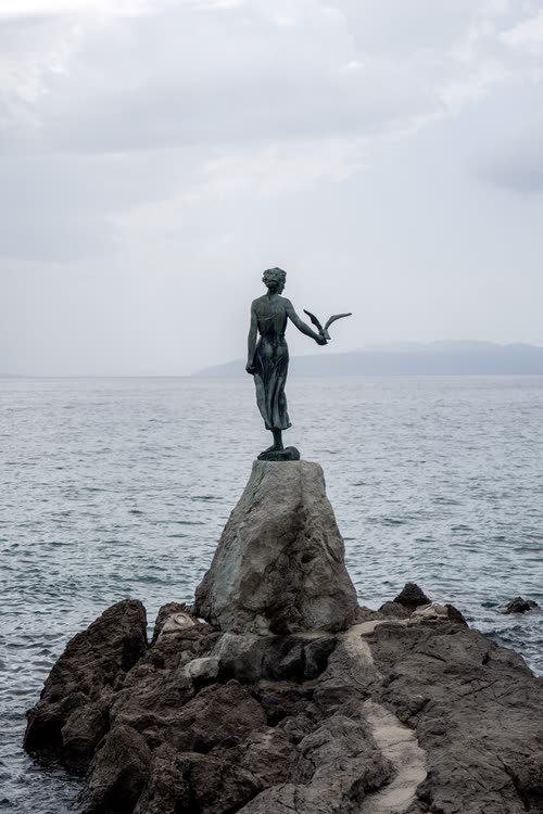 The Maiden with the Seagull statue on the rocks at Opatija, Croatia