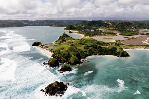 Aerial view of a rocky headland and surf on the south coast of Lombok