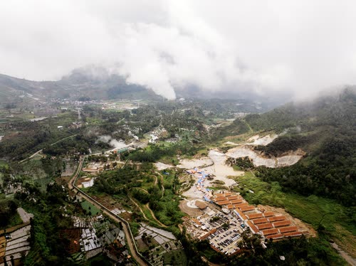 Aerial view of a highland valley with quarry workings under low cloud, Java