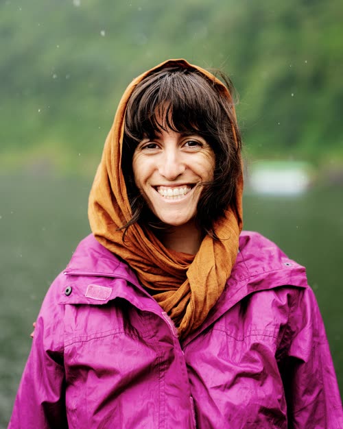 Portrait of a smiling woman in a headscarf in the rain, Indonesia
