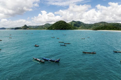 Outrigger fishing boats moored in clear turquoise water off Lombok