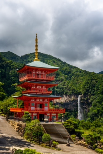 The vermilion three storey pagoda of Seiganto-ji with Nachi Falls behind