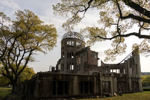 The ruined Atomic Bomb Dome framed by trees in Hiroshima Peace Memorial Park