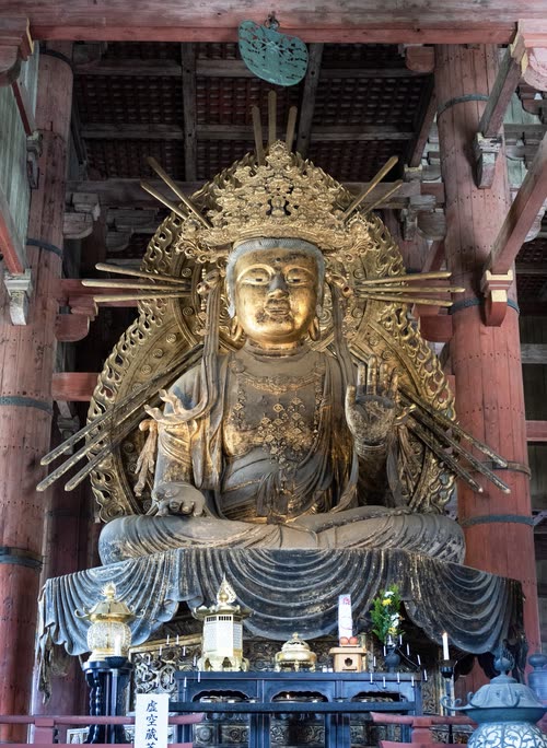 The great gilded Buddha of Todai-ji seated beneath its timber canopy, Nara