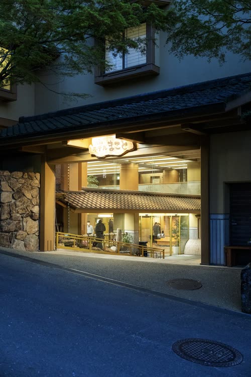 A lit shopfront on a quiet island street at blue hour, Miyajima