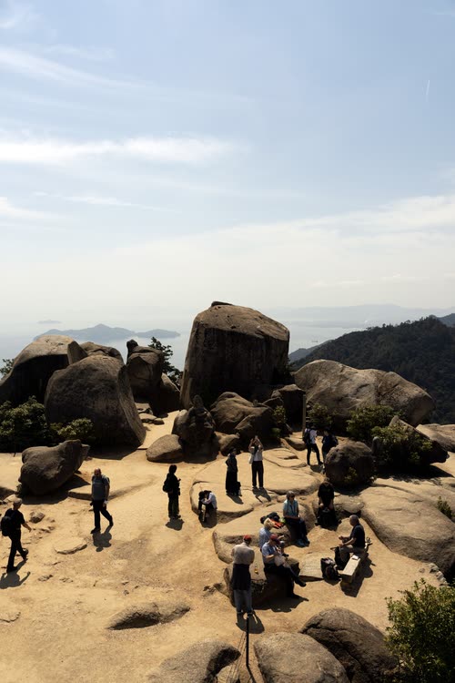 Walkers among the granite boulders on the summit of Mount Misen, Miyajima