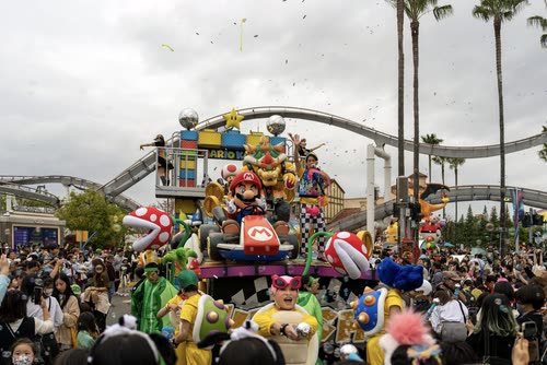 A parade float and costumed performers moving through the crowd at Universal Studios Japan