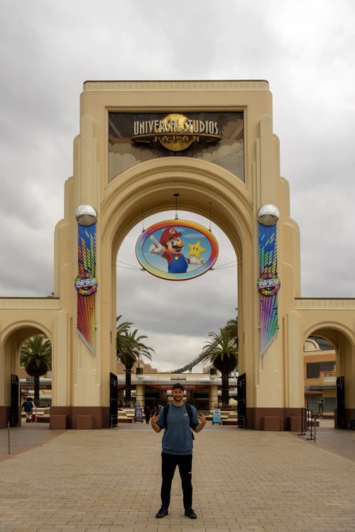 Jordy Scott standing beneath the entrance arch of Universal Studios Japan, Osaka