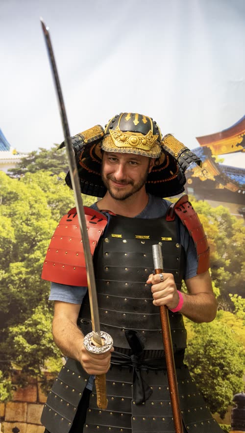 Jordy Scott wearing samurai armour and holding a naginata