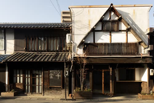 The timber facade and steep gable of a traditional Japanese townhouse