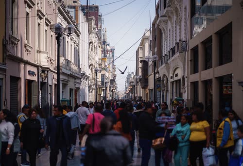 Crowds filling a pedestrian shopping street in central Lima
