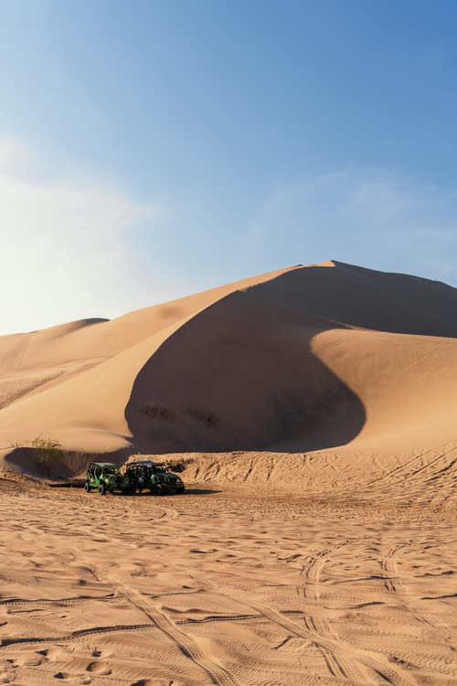 A buggy parked at the foot of a large sand dune at Huacachina