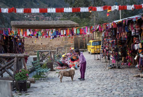 A cobbled market square hung with textiles and bunting in the Sacred Valley