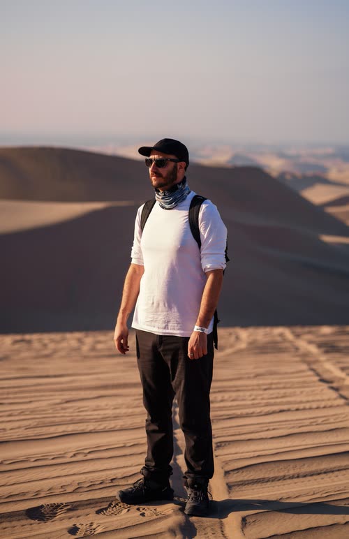 Jordy Scott standing on the sand dunes above Huacachina, Peru