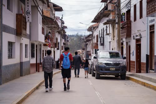 People walking a colonial street of whitewashed buildings in Chachapoyas