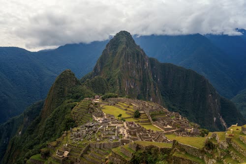 Huayna Picchu rising above the ruins of Machu Picchu with cloud on the ridge
