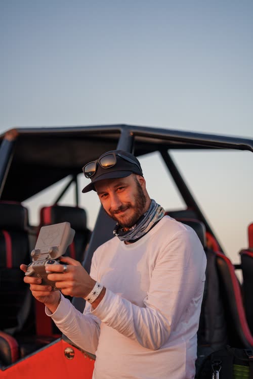 Jordy Scott flying a drone from the back of a dune buggy in the desert