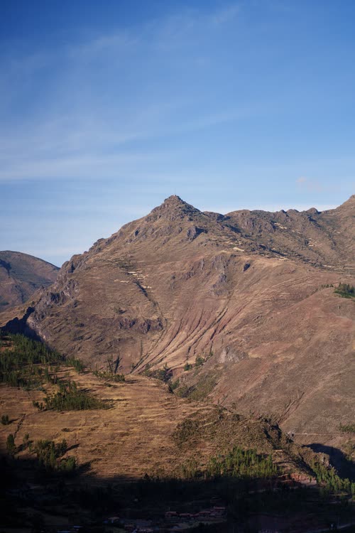 A dry Andean ridge and valley in the strong afternoon light near Cusco