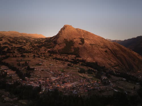 Last light on a red rock peak above a Peruvian mountain town