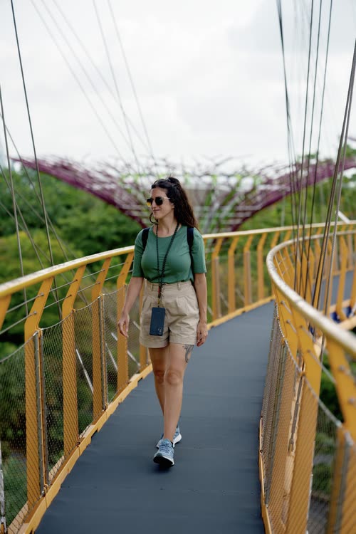 A woman crossing the OCBC Skyway between the Supertrees, Singapore