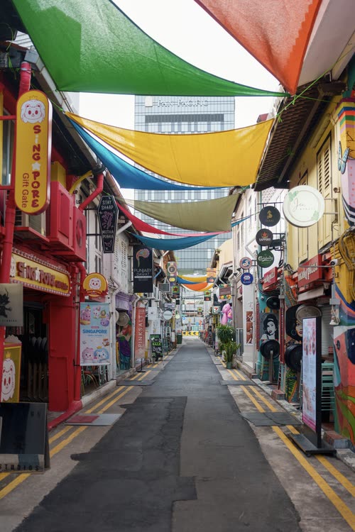 Coloured shade sails strung above a lane of shophouses in Chinatown, Singapore