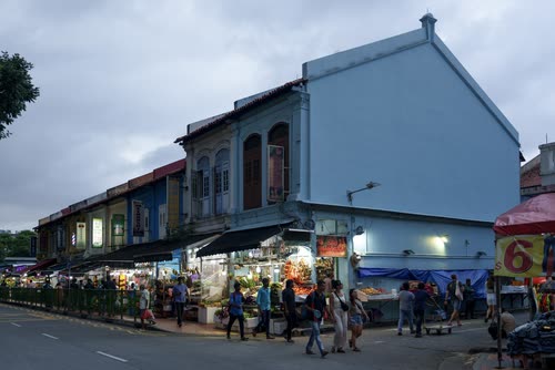 Shoppers on the street outside a row of shophouses in Little India, Singapore