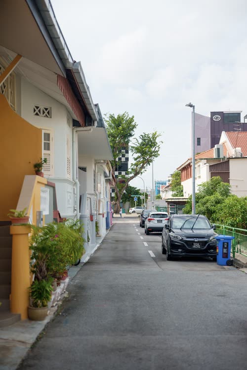 A quiet lane between low pastel shophouses in Singapore