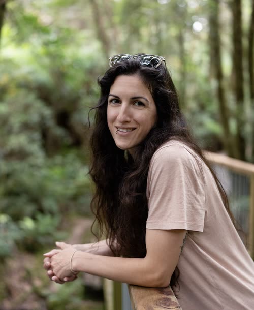 Portrait of a smiling woman on a boardwalk in Tasmanian rainforest