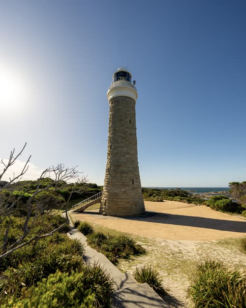 The stone tower of Cape Bruny lighthouse against a bright sky, Tasmania