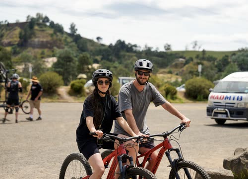 Two mountain bikers at a trail head car park in Tasmania