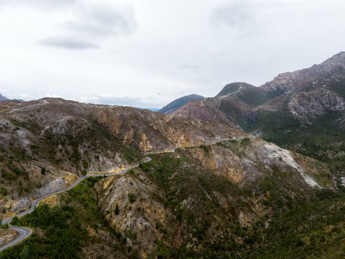 Aerial view of a road winding through the bare mined hills near Queenstown, Tasmania